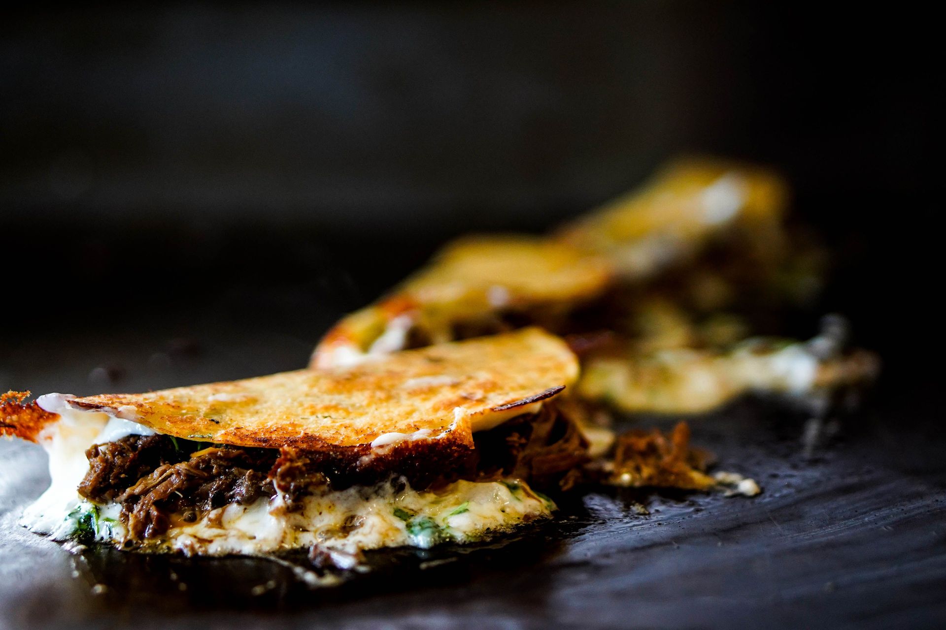 Savor the rich flavors of a cheesy, beef-filled taco sizzling to perfection with a golden crust.